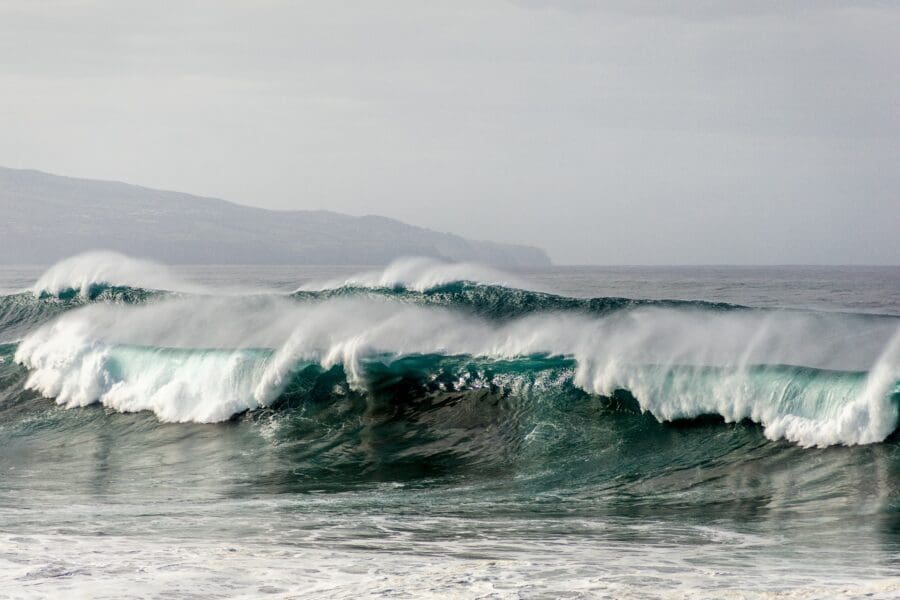 Powerful ocean waves crashing with force, symbolizing the turbulent and overwhelming nature of navigating the waves of grief.