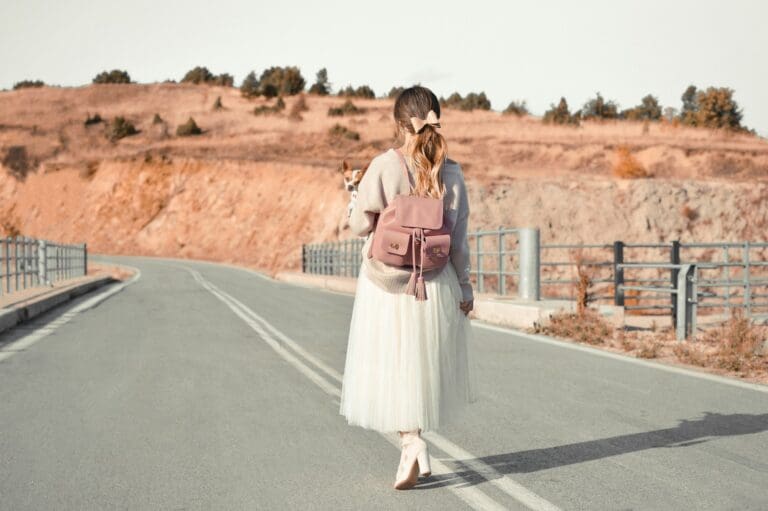 Young woman walking alone on an empty road, symbolizing the journey of coping with trauma, abuse, and the path to parental estrangement.