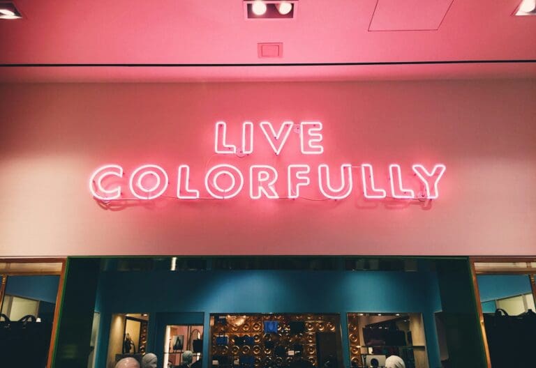 Neon sign reading 'Live Colorfully' symbolizing the vibrant opportunities and personal growth that come with embracing mid-life as a time for transformation and self-discovery.