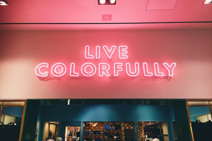 Neon sign reading 'Live Colorfully' symbolizing the vibrant opportunities and personal growth that come with embracing mid-life as a time for transformation and self-discovery.