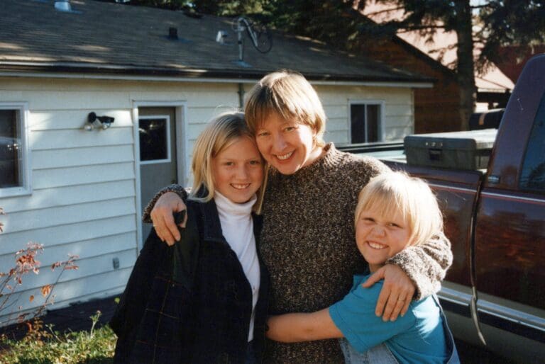 Photo of a woman embracing two young girls, capturing a joyful moment together, symbolizing cherished memories and the profound impact of sudden loss described in a blog article about grappling with the unexpected death of a beloved aunt to cancer.